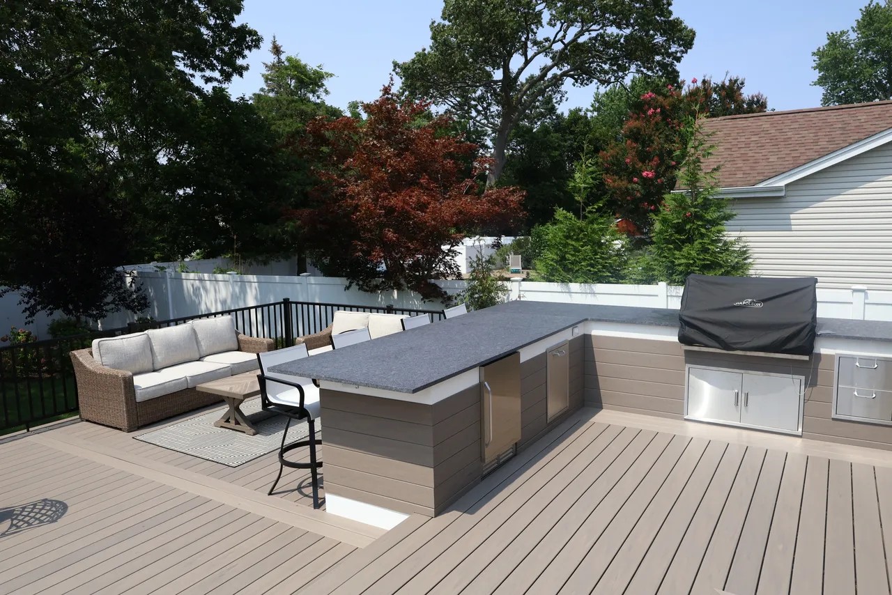 Dining table on a composite deck with white skirted railing