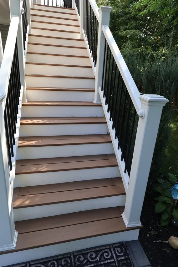 Deck stairs with white rails, black balusters and composite treads