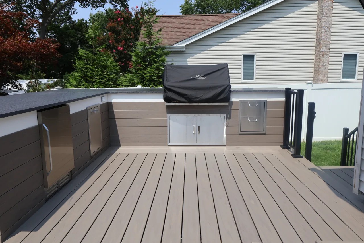 Wicker lounge seating with a tiled coffee table on a two-tone deck