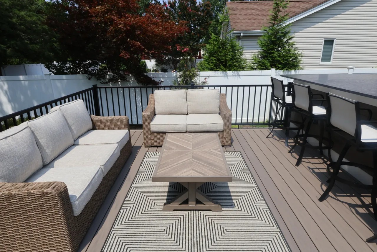 Outdoor kitchen with covered grill, drawers and access doors on a deck
