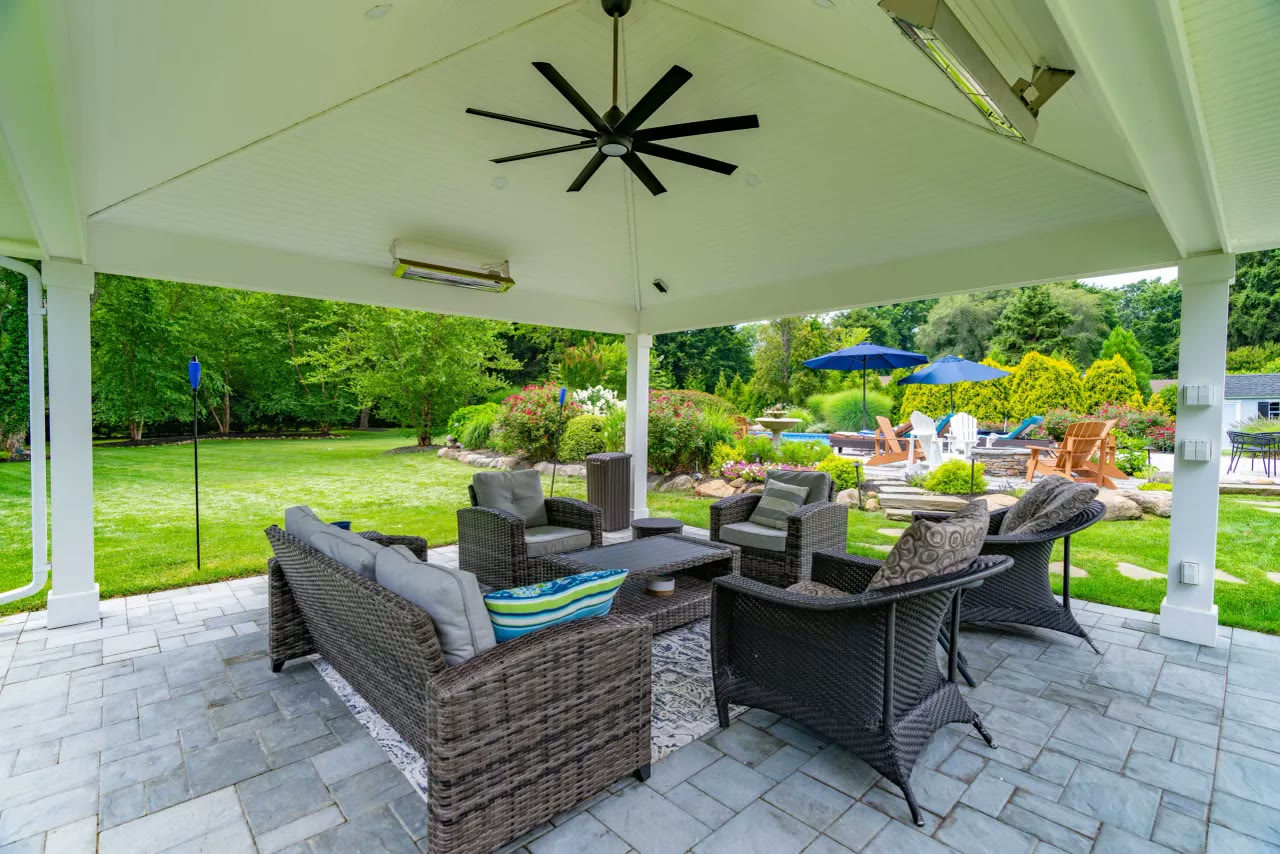 Pavilion lounge with ceiling fan and heaters looking out over the lawn and gardens