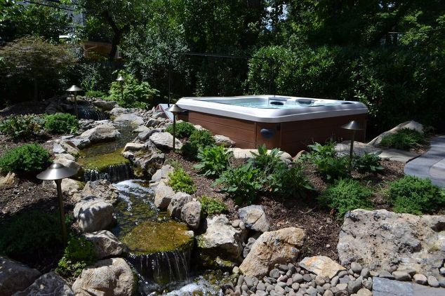 This pondless waterfall/stream was installed beside a portable Bullfrog Spas. The stream is a lovely, tranquil sight from the patio as well as the hot tub itself.