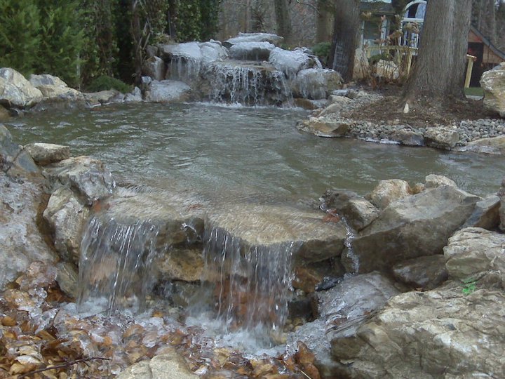 Water Features in Winter: (Long Island/NY) - During a prolonged cold snap, ice forms on the natural stone boulders of this water feature; the water falling over the stones crystalizes into glistening flowing threads — an exquisite sight!