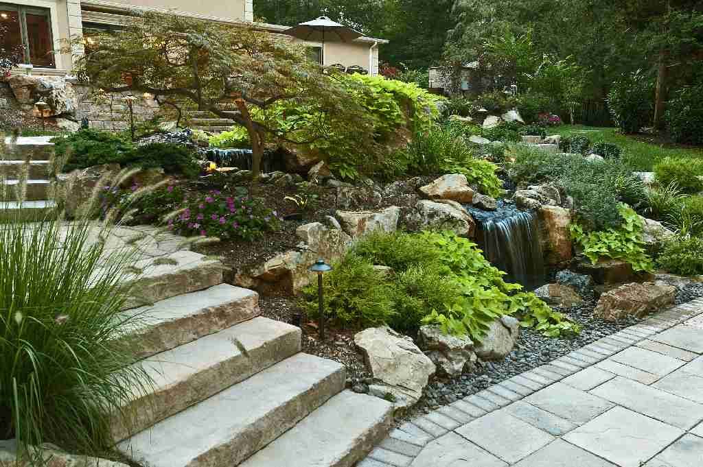 We have a terrific way of cutting costs and increasing the aesthetic value of graded property by using large moss rock boulders instead of expensive and unattractive retaining walls. 