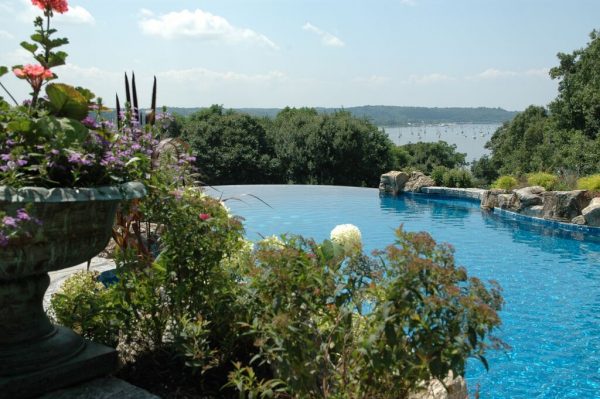 Pool Landscaping (Cove Neck/NY): Landscaping can play a key role in enhancing the experience of an infinity pool and provide other charming “views” while swimming.