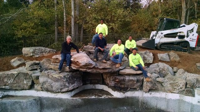 Positioning Swimming Pool Grotto Rock: This is a photo of our team after we finally got the two-ton top grotto rock in place. 