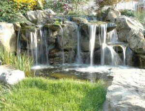 Backyard Water Feature by Deck and Patio