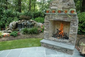 Stand-alone fireplace at the edge of a patio