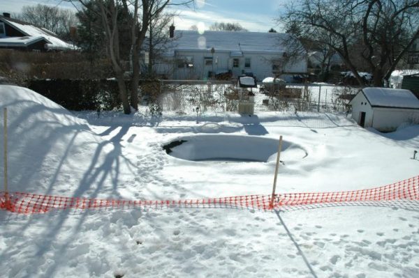 “During.” Winter was upon us not long after we began the project. We did have time to dig out the area for the spa which would give us a head start come spring. Then we covered the hole while we all waited for it to arrive.