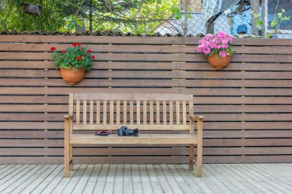 Wooden Bench Beside Brown Wood Fence